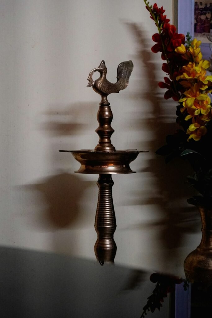 Ornate brass lamp with a peacock crown