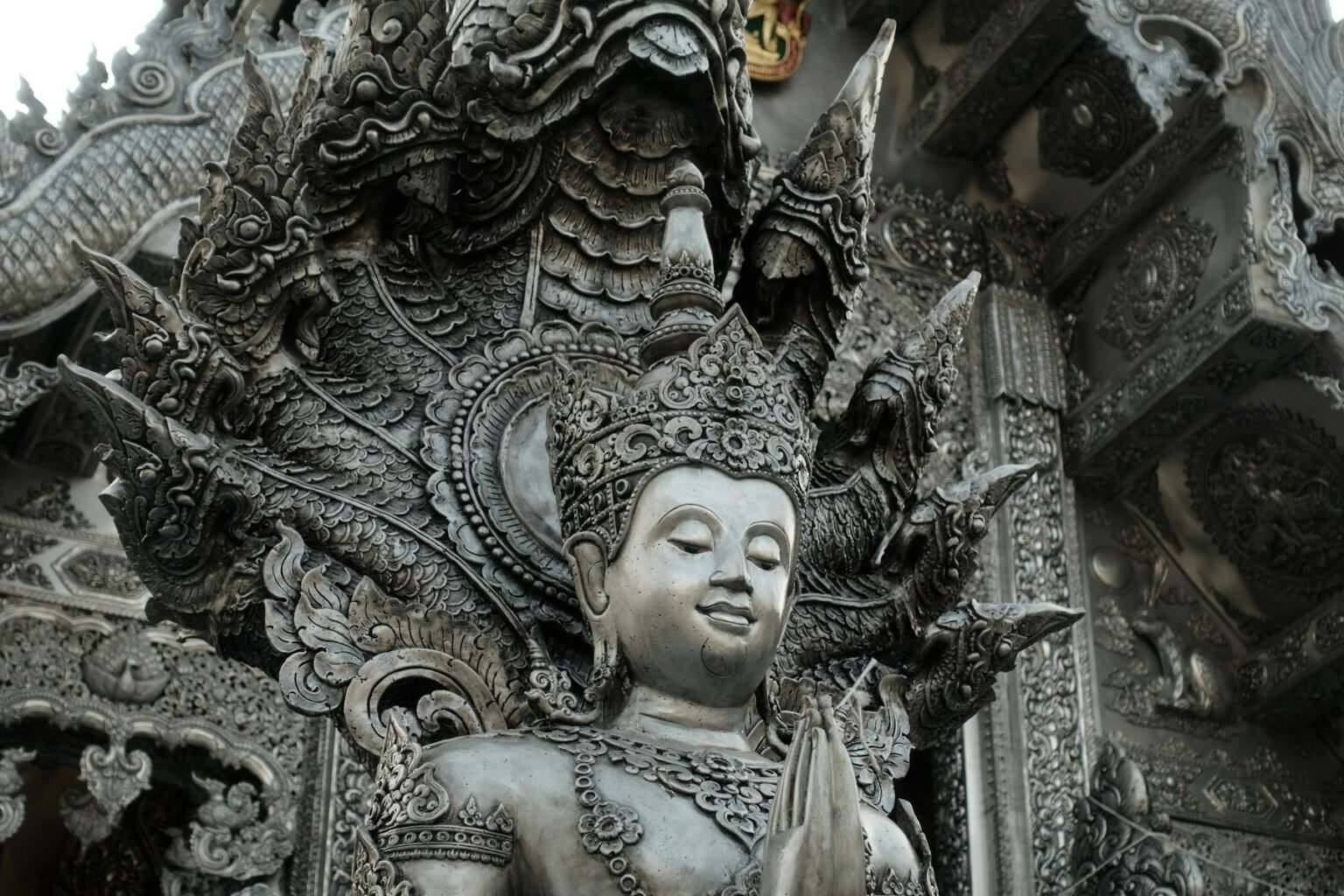 Ornate silver deity sculpture